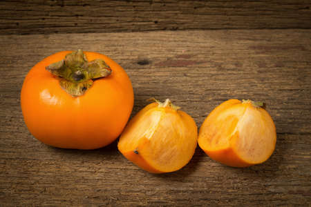 persimmon fruit ripe fresh on old wood.の写真素材