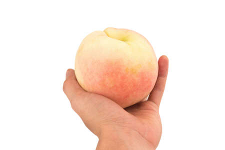 hand hold peach isolated on white background.の写真素材