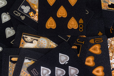 Deck of cards spread out pile gambling black gold.