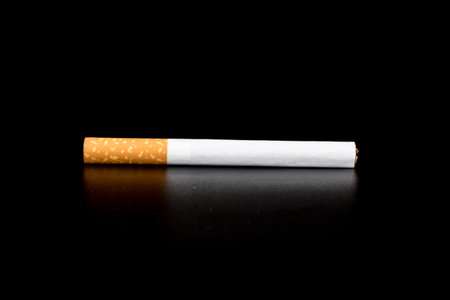 Cigarette butts isolated on black background.の写真素材
