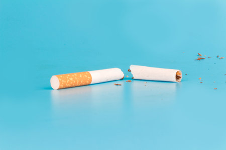 Cigarette butts isolated on blue background.の写真素材