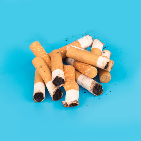 Cigarette butts isolated on blue background.の写真素材