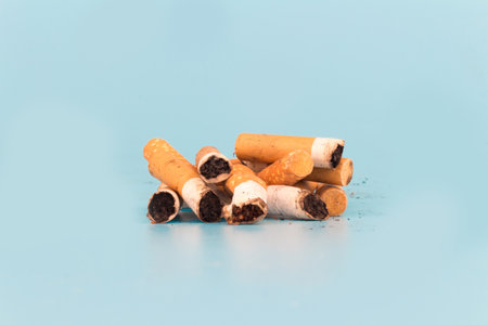 Cigarette butts isolated on blue background.の写真素材