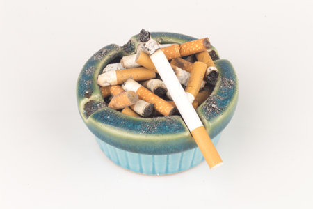 Ashtray butts cigarette on white.の写真素材