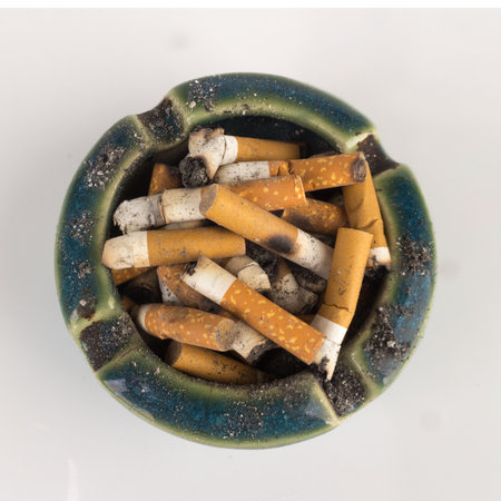 Ashtray butts cigarette on white.の写真素材