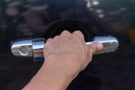 Man's Hand Opening Green Car Door.