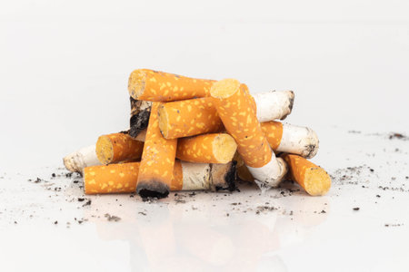 Pile of Cigarette Butts on White Background.
