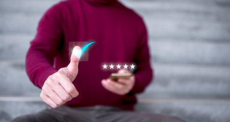 Customer service satisfaction survey concept. businessman thumb up on virtual tick marked giving five stars rating for great customer serviceの写真素材