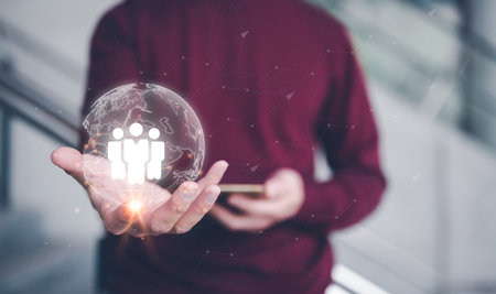 teamwork team leader HRM or Human Resource Management, businessman holding virtual glob with icon in concept of human development team recruitment leadership and customer target group concept.の写真素材