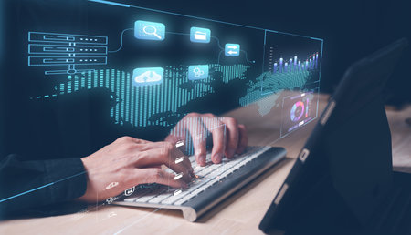 businessman working on keyboard in a concept of data management and data analysis, graph. a man typing on keyboard looking at chart data. internet network, data transsformation technology.の写真素材