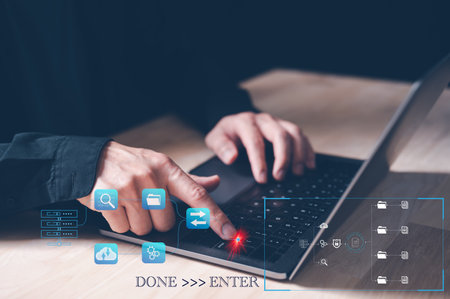 the concept of finished job done, businessman working with computer laptop pressing enter button for finishing work. save work, done and enter. finalise, submitting.の写真素材
