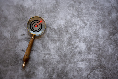 business goal, Target board inside magnifier glass for focus business objective on  background and copy space. Search, goal, strategy, success.の写真素材