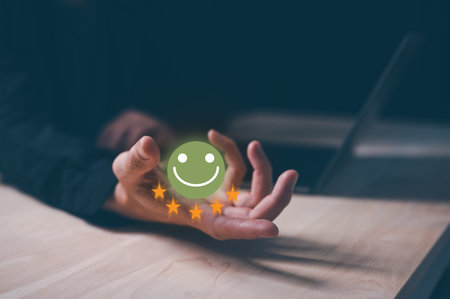 Customer service satisfaction survey concept.Business people or customers show satisfaction by holding face emoticon smile in satisfaction on virtual touch screen.の写真素材