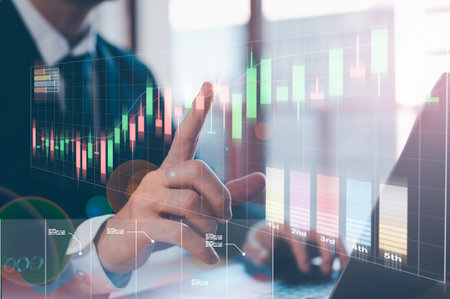 trading stock market, invesment concept, businessman working on computer laptop and virtual trading graph in office blurred backgroundの写真素材