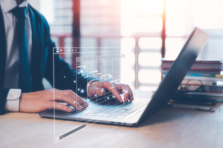 businessman, Analyst doing an Analytics and Data Management System on laptop computer, report with KPI and metrics database. Corporate strategy for finance, operations, sales, marketing.の写真素材