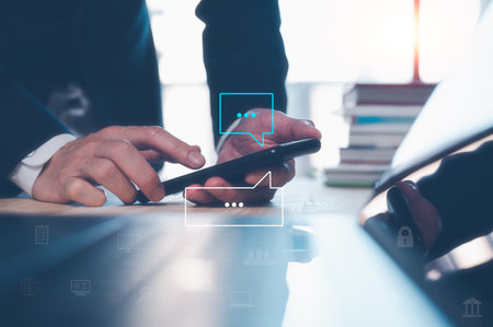 businessman using smartphone typing, chatting conversation working from home in chat box icons pop up. Social media maketing technology concept.の写真素材