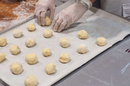 making Brazilian cheese bread pao di Kejo, making dough. Dough placed on a baking sheet.