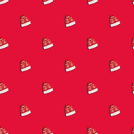 Christmas red hat with deers on red background, seamless pattern. Santa Claus hatの写真素材