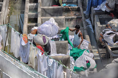 Mumbai, India-March 03,2013: Laundry Dhobi Ghat in Mumbai, people wash clothes on a city street. India's biggest washの写真素材