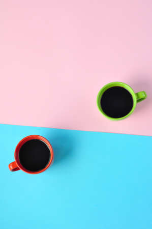 Americano in the different cups on the pink background.の写真素材