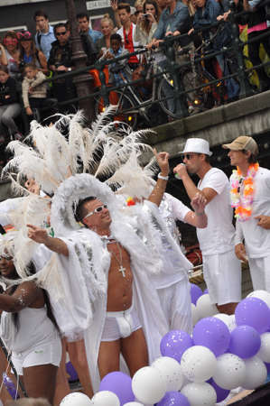 Amsterdam, Holland - August 04, 2012: People celebrate the gay parade, celebration on the canals of Amsterdam. People with lgbt flags.のeditorial素材