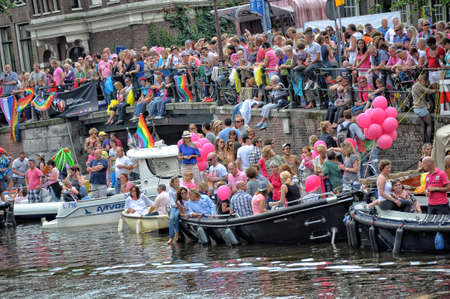 Amsterdam, Holland - August 04, 2012: People celebrate the gay parade, celebration on the canals of Amsterdam. People with lgbt flags.のeditorial素材