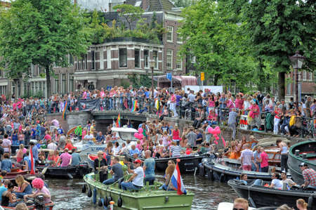 Amsterdam, Holland - August 04, 2012: People celebrate the gay parade, celebration on the canals of Amsterdam. People with lgbt flags.のeditorial素材