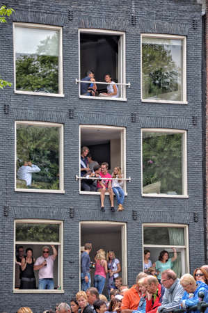 Amsterdam, Holland - August 04, 2012: People celebrate the gay parade, celebration on the canals of Amsterdam. People with lgbt flags.のeditorial素材