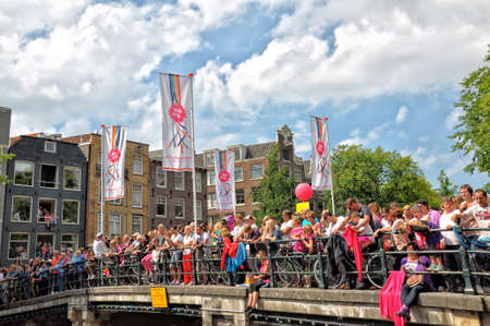 Amsterdam, Holland - August 04, 2012: People celebrate the gay parade, celebration on the canals of Amsterdam. People with lgbt flags.のeditorial素材