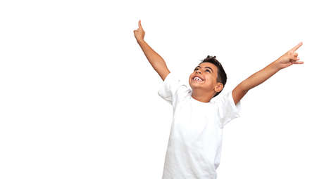 a young black boy expresses delight by raising his hands up and shouting hurray. On a white background, horizontal orientationの写真素材