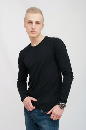 Young blonde man portrait in studio on gray backgroundの写真素材