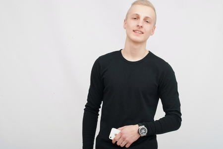 Young blonde man portrait in studio on gray backgroundの写真素材