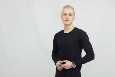 Young blonde man portrait in studio on gray backgroundの写真素材