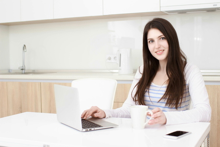 Business woman working from her home. Multitasking.の写真素材