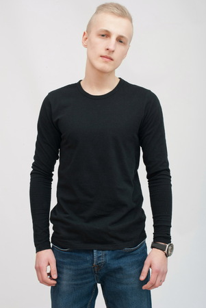 Young blonde man portrait in studio on gray backgroundの写真素材