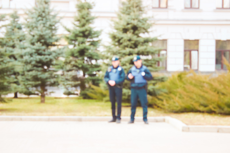 Policemen stand on the street and watch their two photographs razmtaya for the background it's easy to write on itの写真素材