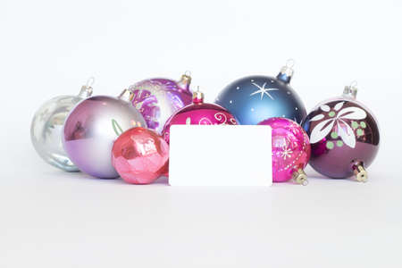 Arrangement of Christmas tree decorations and white card  white backgroundの写真素材