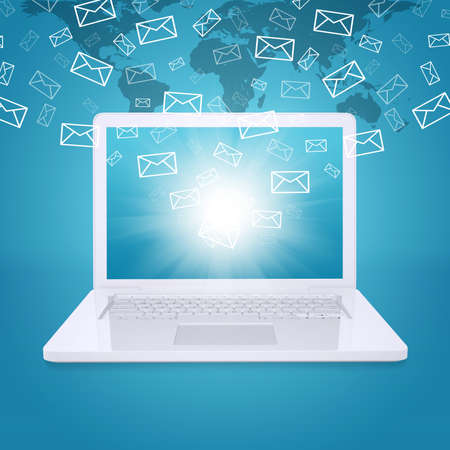 Emails fly out of laptop screen  The concept of e-mailingの写真素材