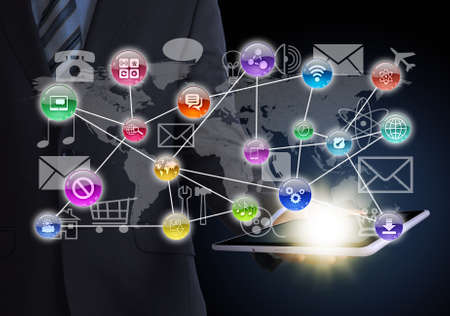 Man in suit holding tablet in hand  Application icons around tablet  The concept of software