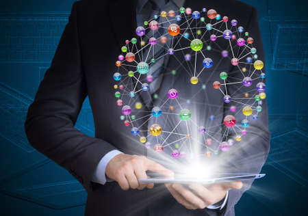 Man in suit holding tablet pc and application icons in hand