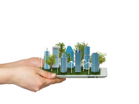 Hands holding a tablet computer  In screen tablet city of skyscrapers