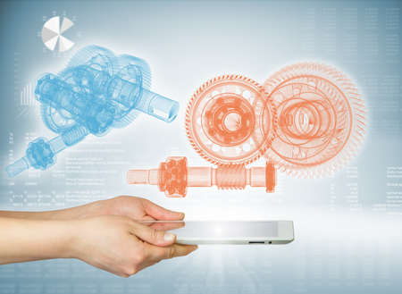 Hands holding a tablet  Above the screen of the tablet are gears  Hi-tech backgroundの写真素材