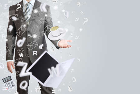 Man in a suit holds her hand in front of him  Office objects are emitted from the palm  The concept of office workの写真素材