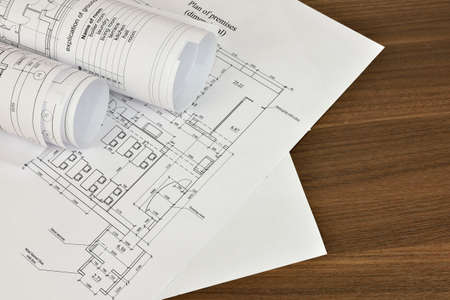 Construction drawings on a wooden surface  Workplace architect