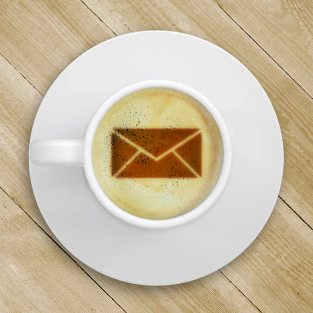 Cup of coffee standing on a wooden surface  Picture of the mail in the coffee crema  top view