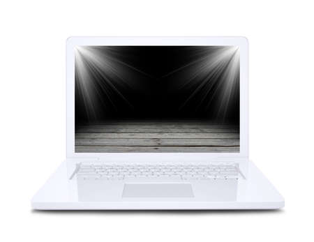 On the laptop screen shows a wooden floor floodlit  Isolated on white backgroundの写真素材