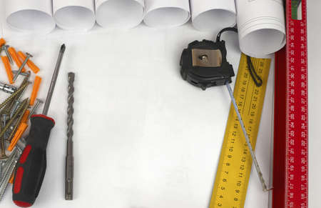 Scrolls of architectural drawings and tools  Desk builder