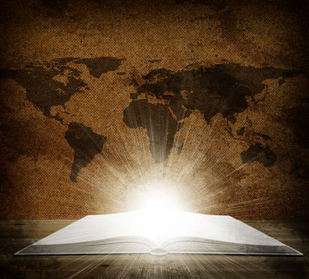 Over an open book is a map of the earth  Grunge style