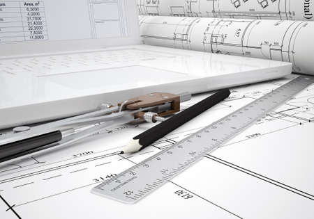 Scrolls architectural drawings and laptop  architect concept
