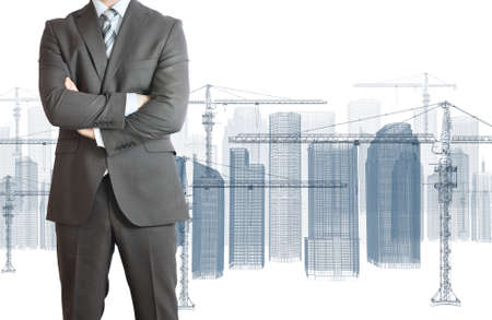 Businessman in suit  Wire frame tower crane and skyscrapers on the backgroundの写真素材